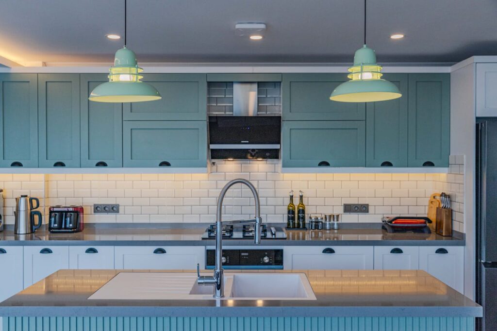 A kitchen with blue cabinets and white counter tops